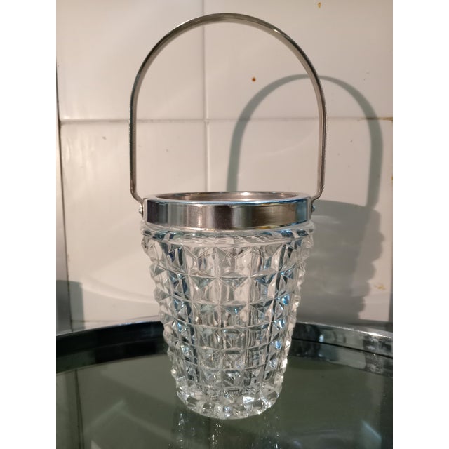 Detail of a ground glass ice bucket with steel tongs from the 1960s.