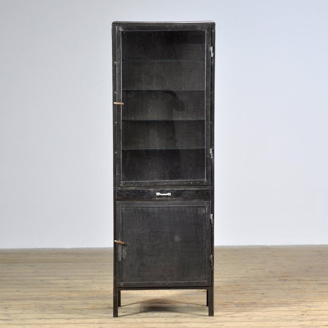 Medicine cabinet from the 1950s, manufactured in former Yugoslavia. This cabinet is made of iron and glass, creating a...