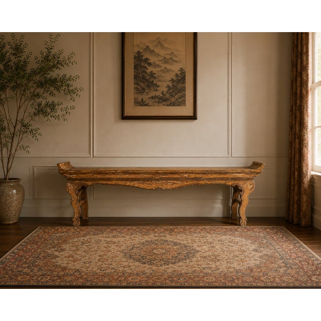 A striking mid-20th century Chinese altar console table featuring a beautifully timeworn lacquered finish and classic...