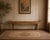 A striking mid-20th century Chinese altar console table featuring a beautifully timeworn lacquered finish and classic...