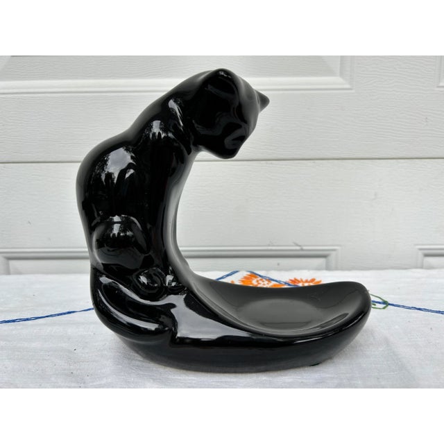 This Royal Haeger Black Cat figural stand is glazed in a black glaze and finished in a high gloss. This piece is unmarked,...