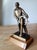 Vintage Nautical Sculpture Bronze-finish sailor statue by sculptor Ferdinand G. Rebechini, depicting a helmsman standing...