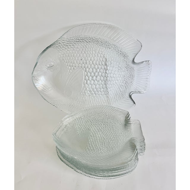 This set of 12 plates and 2 serving platters made by Arcoroc France in the 60s and 70s features a distinct textured...