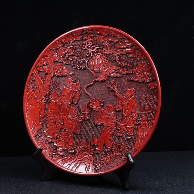 This is a substantial and exquisitely crafted carved lacquer charger (or display plate), featuring deep, intricate relief...