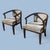 A handsome pair of vintage armchairs with gracefully curved wood frames, wraparound arms, and tailored neutral upholstery....