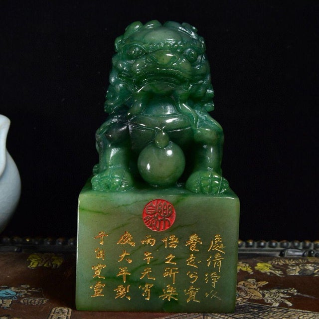 This impressive Shoushan stone seal features a finely carved guardian lion seated atop a square base. The lion is depicted...