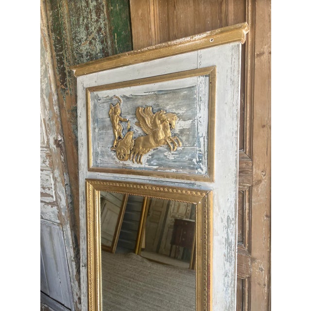 Beautiful French trumeau mirror, featuring a lovely blue and white patina, with gilt wood accents. This mirror features...