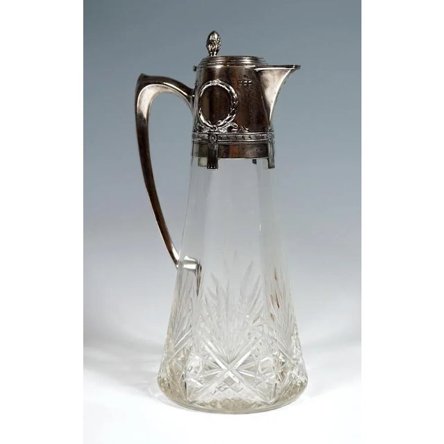 Carafe made of clear glass with a conical body, the inside six-pointed wave-shaped thickened wall, cut near the base with...