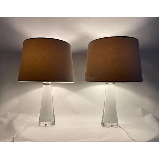 Table lamps in crystal, model rd 1566 by carl fagerlund for orrefors, sweden. The lamps have a white color with clear...