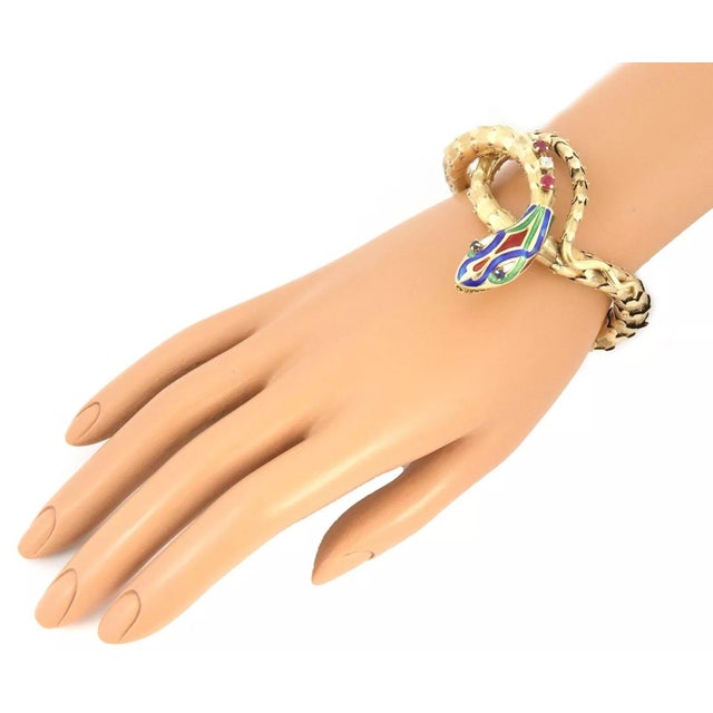 This is a vintage eye-catching bracelet, crafted from 14k yellow gold featuring a long flexibles curled hallow body of a...