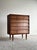 This vintage mid century five-drawer dresser features a clean architectural silhouette with stepped drawer fronts,...