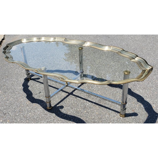 Brushed Steel chrome And SOLID Brass Scalloped and Glass Tray Top Cocktail Table. Good vintage condition. Minor tarnish on...