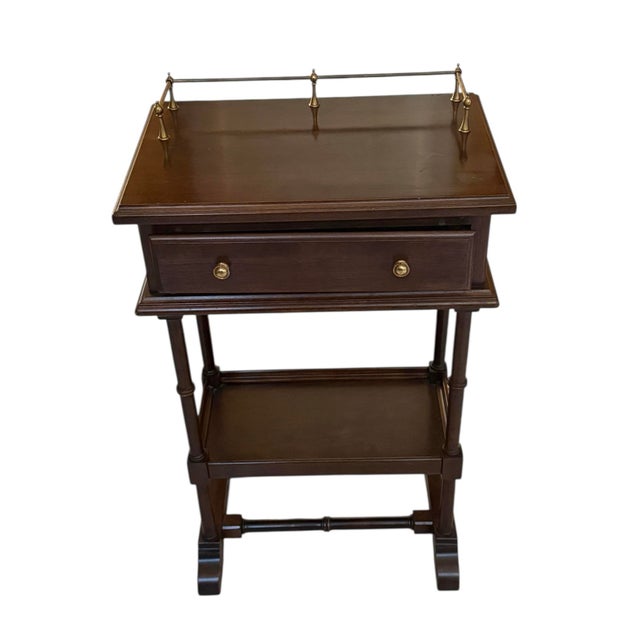 This Ethan Allen Georgian Court side table exudes understated elegance and practicality. Crafted from solid cherry wood,...