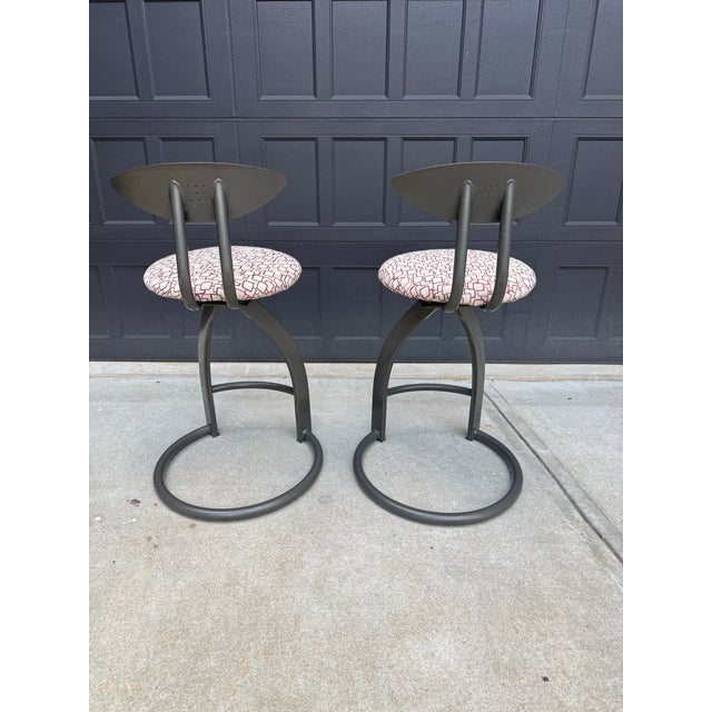Elevate your kitchen or entertaining space with this stylish pair of contemporary modern industrial swivel counter stools....