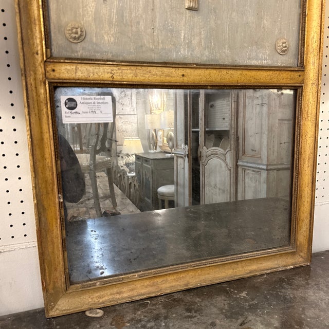 This is a 19th century French Louis XVI style trumeau mirror with musical attributes, an elegant decorative form that...