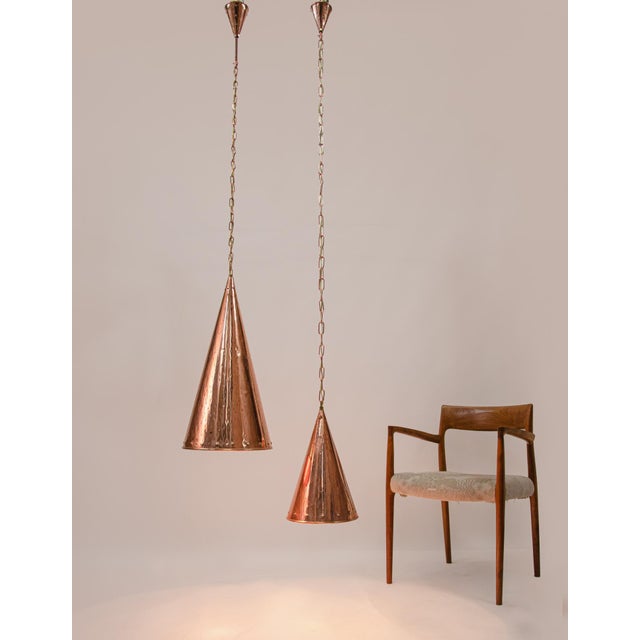 Elegant pair of danish hand-hammered copper cone pendant lamps hanging on long chains. Designed and manufactured by e.s...