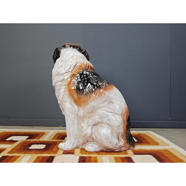 Life size St Bernard dog sculpture made from Glazed terracotta. This impressive sculpture showcases a somewhat sad looking...