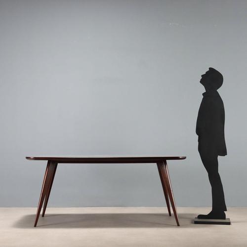 Vintage Italian-made dining table with stained beech wood legs, rectangular top with beveled corners and backed by grey-...