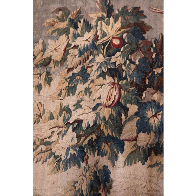 Important 18th-century Aubusson tapestry depicting a lush landscape with a pagoda and dwelling, colorful birds, and a body...