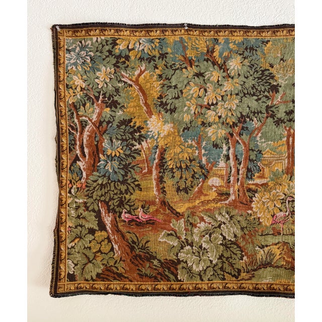 A wonderful French Verdure reproduction tapestry from the mid-20th century. This traditional Aubusson tapestry features a...