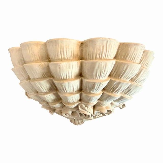 A striking pair of 19th century wall sconces from France, modeled as scallop shells in the Rococo taste and finely worked...