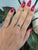 A natural color-change alexandrite sits at the centre of this solid two-tone 14K white and yellow gold ring, flanked by...