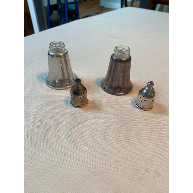 Elegant pair of silver salt and pepper shakers. Glass lined.