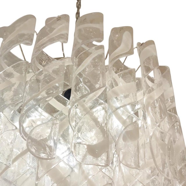 A unique and technically complex piece, composed of countless individual fusilli-shaped or stylized spirals that combine...