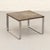 Small coffee table by Peter Draenert, combining fossil-bearing slate with brushed stainless steel. The grey-green stone...