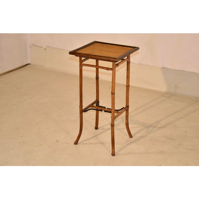 19th century bamboo side table from France. The top is banded with a molded edge, surrounding what appears to be the...