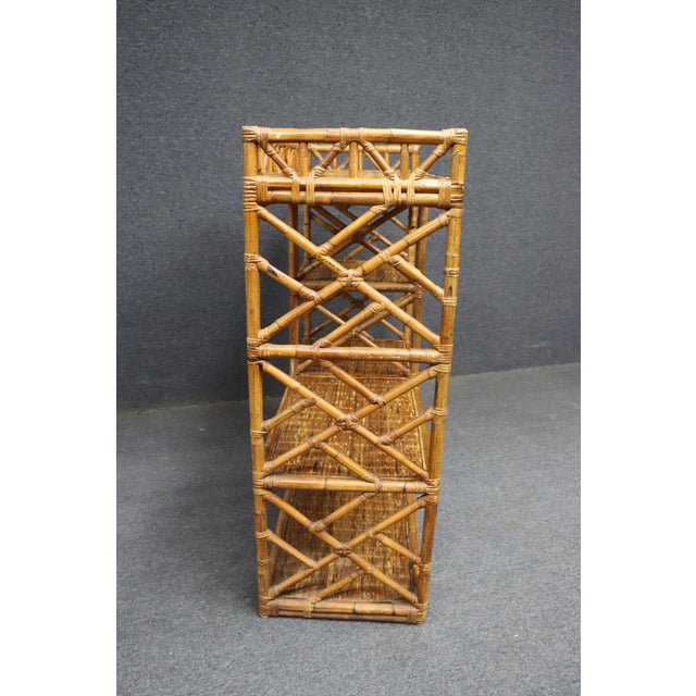 Charming mid-century bamboo fern stand featuring an open lattice frame and woven rattan shelves. The warm honey-toned...