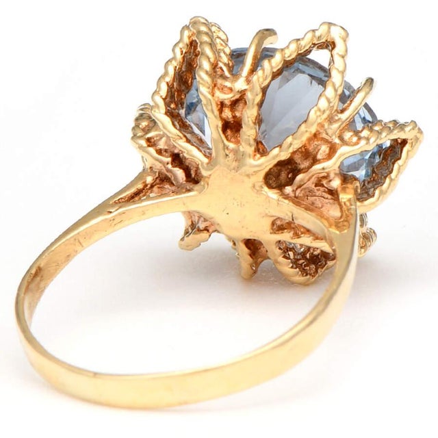 This vintage synthetic spinel ring evokes a sensuous mood. A crown of yellow gold holds the faceted light blue stone and...