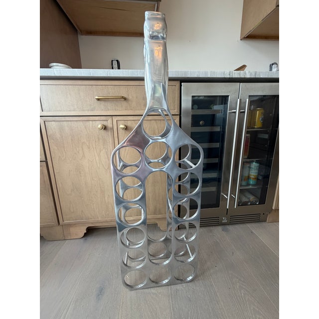 Simple, elegant and playful in the shape of a tall bottle. This cast aluminum wine rack can sit on the floor or on the...