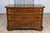 An Italian walnut and ash three-drawer commode from circa 1690 with inlaid décor, canted side posts and ogee bracket feet....