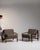 This pair of armchairs carries genuine presence, its taupe upholstery, dark wood frame immediately setting the tone for...