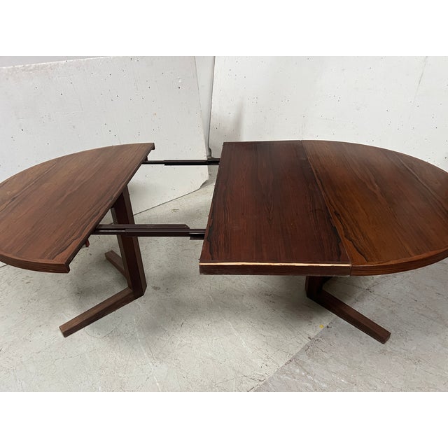 Round extendable dining table in rosewood veneer designed by john mortensen for heltborg mobler danish table with two...