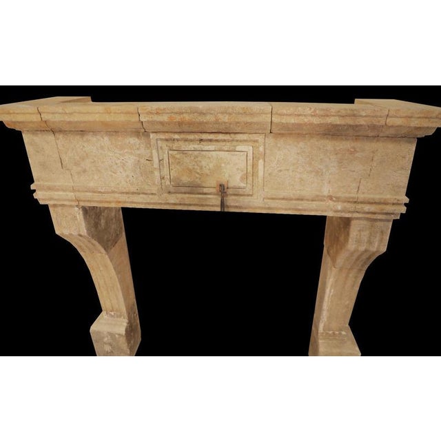 with its understated elegance and rustic charm, this 20th-century hand-carved limestone fireplace mantle captures the...