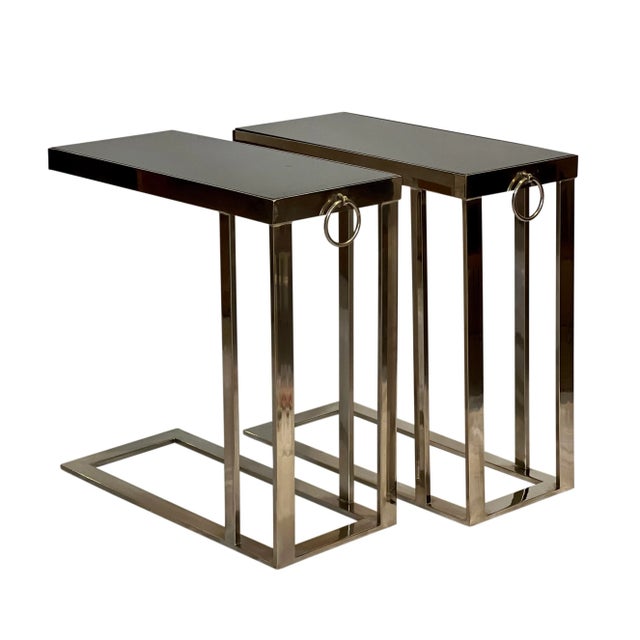 Sleek flat bar chromed steel cantilever side tables with inset black marble tops and bullnose ring detail, late 20th...