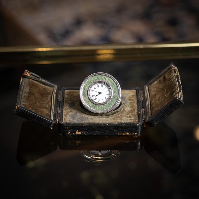 Antique early-20th century edwardian solid silver desk clock of circular form, featuring a roman numeral dial surround...