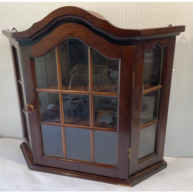 Nice vintage Dutch wall cabinet with glass front and sides and two shelves.