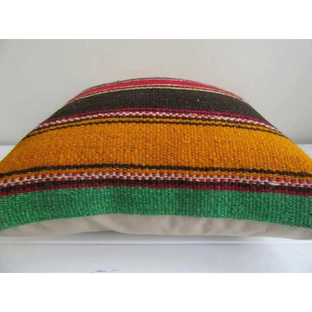 This is a pillow cover made from a vintage kilim rug. The piece was properly washed and ready to use. Pillow inserts not...