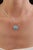 This halo pendant features a 1.46 carat natural round turquoise, set in 14K white gold. The center stone measuring 8 mm in...