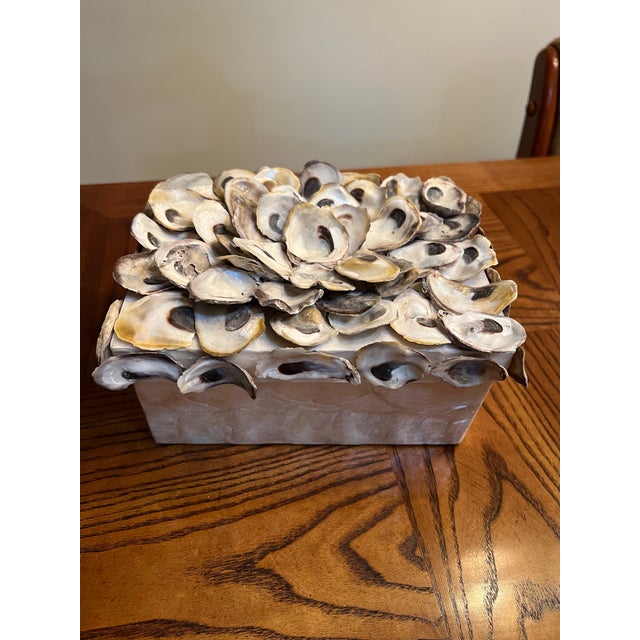 Beautiful handmade oyster shell decorative box featuring a coastal design. This decorative piece is crafted using real...