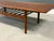 A mid century modern teak coffee table with a slatted magazine lower rack designed by Grete Jalk for Glostrup....