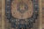 This 6x10 antique Khotan rug, hand-knotted in wool circa 1920–1929, features two geometric medallions on a deep indigo...