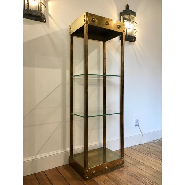 This studded solid brass stunner of an etagere is the perfect piece for displaying items! The raw brass has the perfect...
