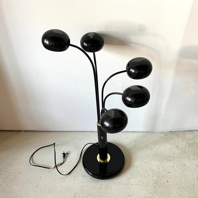 Post-Modern 5-arm black enamel "eyeball" spider lamp with white enameled interior and gold-tone detailing. On/off switch...