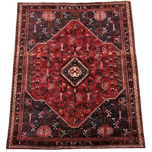 A richly colored vintage hand-knotted tribal rug attributed to the Shiraz/Qashqai weaving tradition of southwestern...