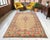 Hand-knotted in the Aegean Anatolia region during the 1900s, this authentic Oushak area rug exemplifies the unparalleled...