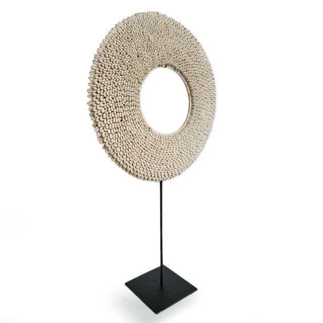 Beautiful vintage cowry shell ring displayed on black iron stand. Intricate embroidered white cowry shells make and...